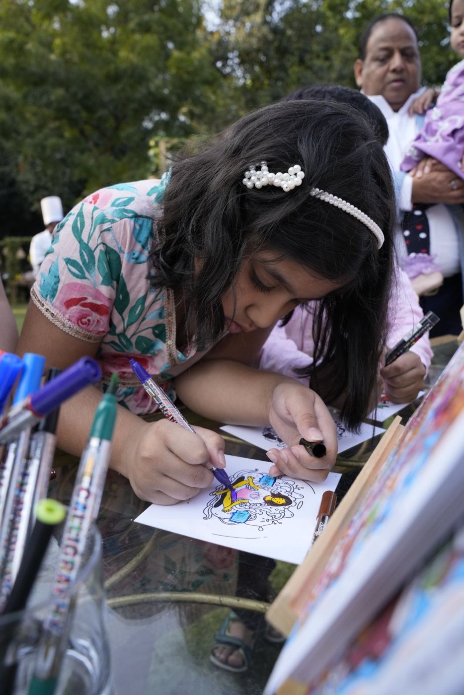 Child holding her doodle at a workshop